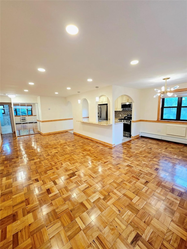 505 Central Ave Unit 211, White Plains, NY 10606 - unfurnished living room with baseboard heating, recessed lighting, a chandelier, and baseboards