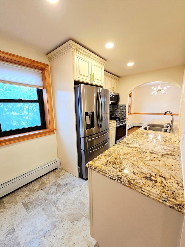 505 Central Ave Unit 211, White Plains, NY 10606 - kitchen featuring a sink, appliances with stainless steel finishes, arched walkways, light stone counters, and a chandelier