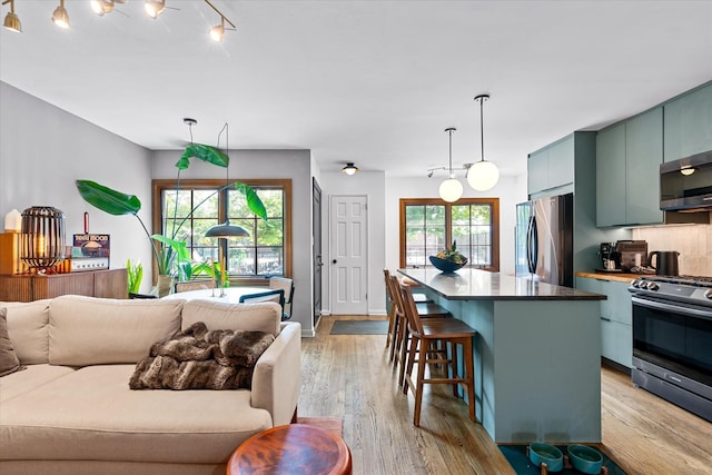 209 Onderdonk Ave, Ridgewood, NY 11385 - living area with light wood-style flooring and healthy amount of natural light