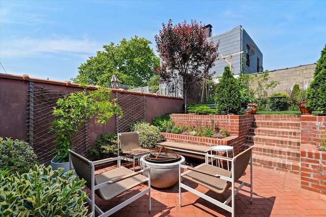 209 Onderdonk Ave, Ridgewood, NY 11385 - fenced backyard featuring a patio and an outdoor fire pit