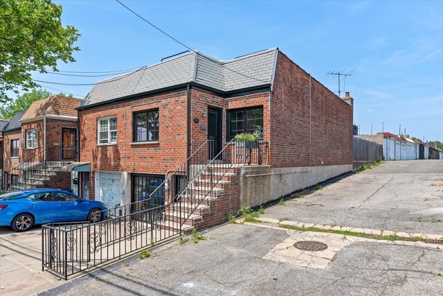 209 Onderdonk Ave, Ridgewood, NY 11385 - view of side of property with brick siding and mansard roof