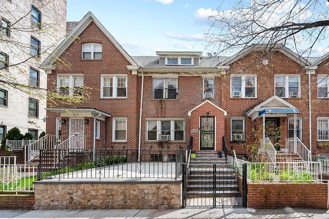 3415 91st St, East Elmhurst, NY 11369 - townhome / multi-family property featuring brick siding, a fenced front yard, and a gate