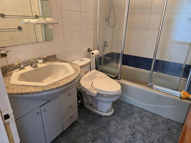 152-18 Union Tpke Unit 11J, Kew Garden Hills, NY 11367 - bathroom with tile walls, bath / shower combo with glass door, vanity, toilet, and decorative backsplash