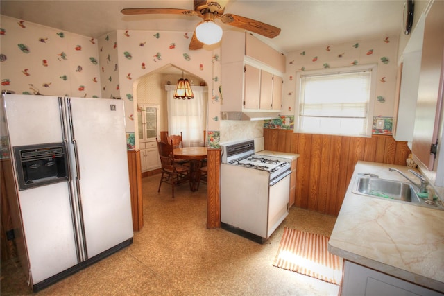 115-31 237th St, Elmont, NY 11003 - kitchen with wallpapered walls, white appliances, ceiling fan, a sink, and light countertops