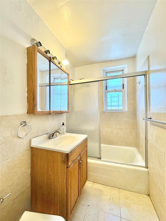 86-16 60th Ave Unit 5K, Elmhurst, NY 11373 - bathroom with vanity, enclosed tub / shower combo, tile patterned flooring, and tile walls