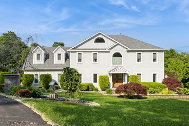 61 Sherwood Hts, Wappingers Falls, NY 12590 - view of front of house with a front lawn, stucco siding, and roof with shingles