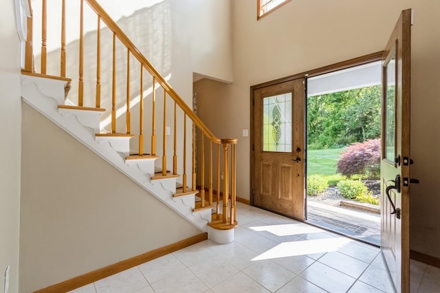61 Sherwood Hts, Wappingers Falls, NY 12590 - entryway with stairway, baseboards, tile patterned floors, and a towering ceiling