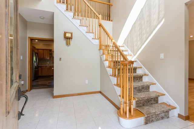 61 Sherwood Hts, Wappingers Falls, NY 12590 - stairway featuring a high ceiling, tile patterned floors, and baseboards
