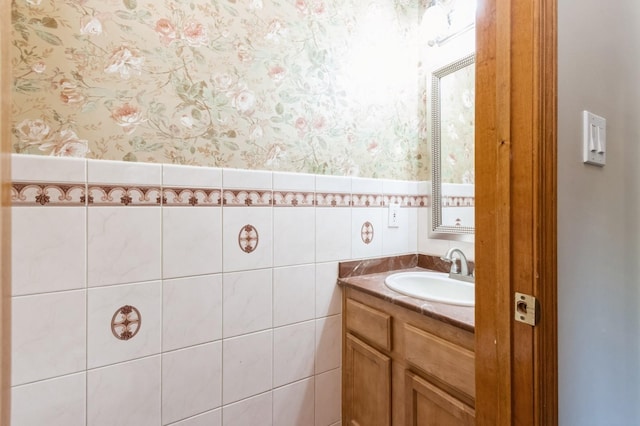 61 Sherwood Hts, Wappingers Falls, NY 12590 - bathroom featuring vanity, wallpapered walls, tile walls, and a wainscoted wall