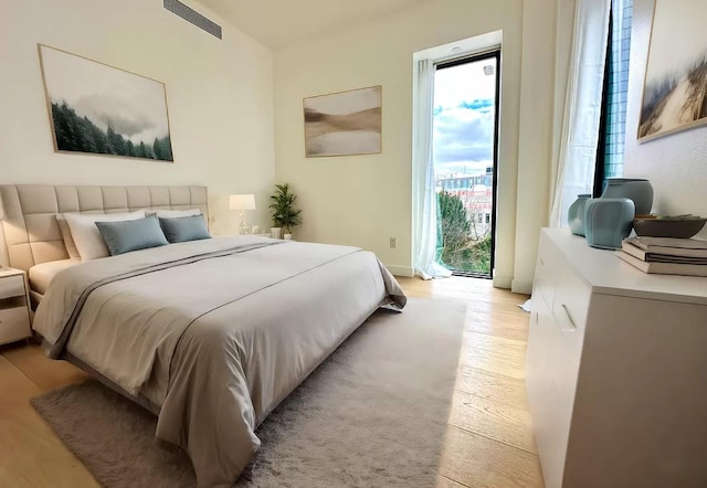 3005 Vernon Blvd Unit 4H, Astoria, NY 11102 - bedroom featuring access to exterior and light wood-style flooring