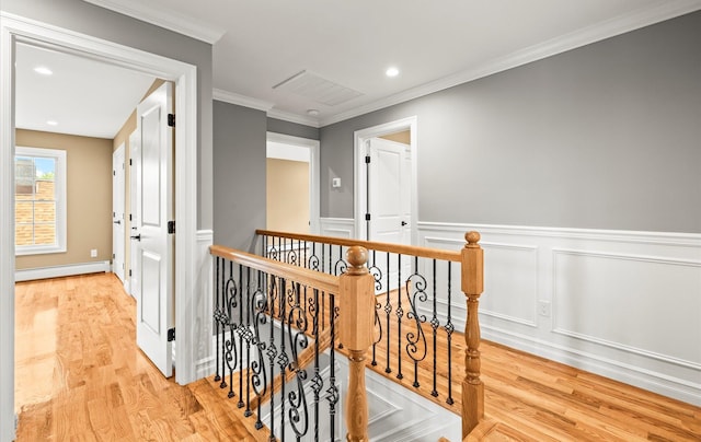 1850 Voshage St, Baldwin, NY 11510 - hallway with baseboard heating, wood finished floors, an upstairs landing, crown molding, and wainscoting