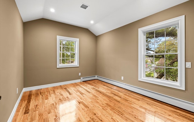1850 Voshage St, Baldwin, NY 11510 - spare room featuring baseboard heating, wood finished floors, vaulted ceiling, baseboards, and recessed lighting