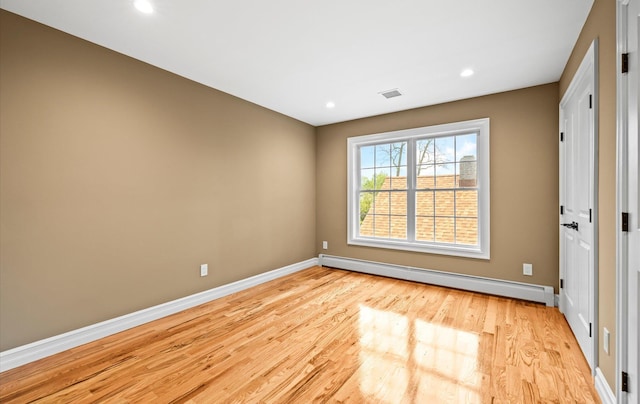 1850 Voshage St, Baldwin, NY 11510 - empty room featuring baseboard heating, baseboards, light wood-style floors, and recessed lighting