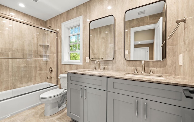 1850 Voshage St, Baldwin, NY 11510 - full bathroom with toilet, double vanity, and shower / bath combination with glass door