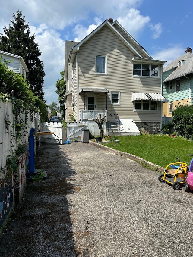 12 Ferdinand Pl, New Rochelle, NY 10801 - rear view of house featuring a gate