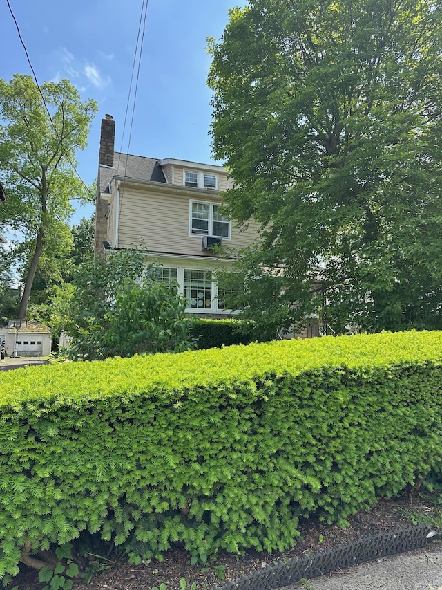 12 Ferdinand Pl, New Rochelle, NY 10801 - view of property exterior with a chimney