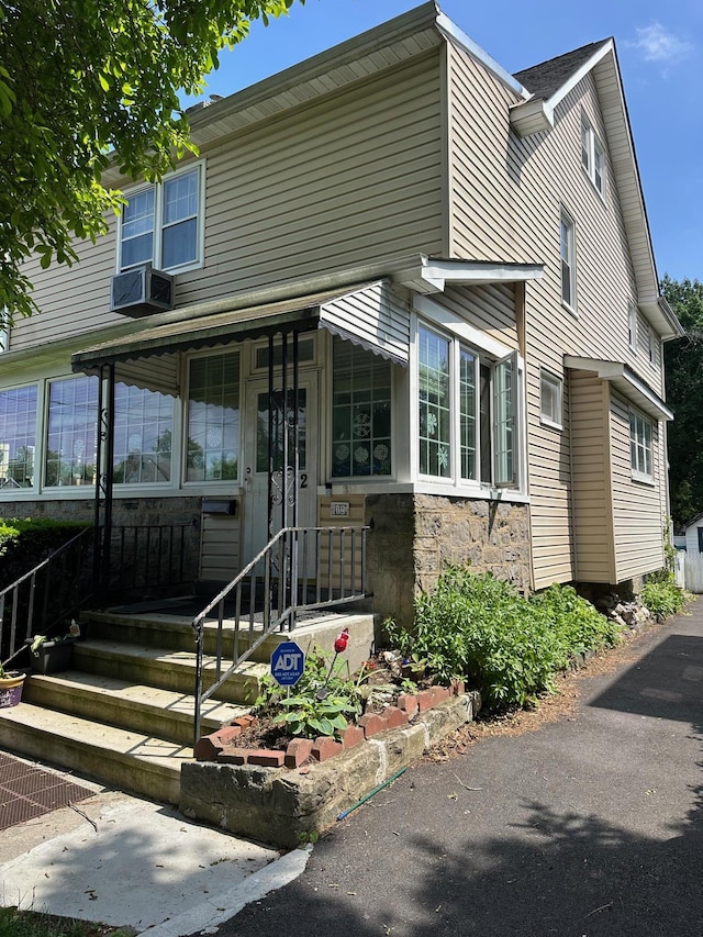 12 Ferdinand Pl, New Rochelle, NY 10801 - view of front of house with stone siding and cooling unit