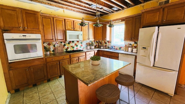 28 Hynard Pl, Baldwin Place, NY 10505 - kitchen featuring white appliances, brown cabinetry, a center island, a sink, and backsplash