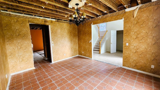 28 Hynard Pl, Baldwin Place, NY 10505 - unfurnished room with a chandelier, stairway, and baseboards