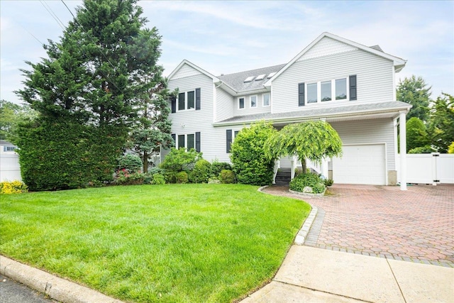 1360 Powell Ave, Merrick, NY 11566 - view of front of home with an attached garage, decorative driveway, and roof with shingles