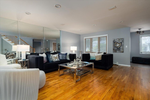 1360 Powell Ave, Merrick, NY 11566 - living room featuring light wood-style floors, a baseboard radiator, a chandelier, and recessed lighting