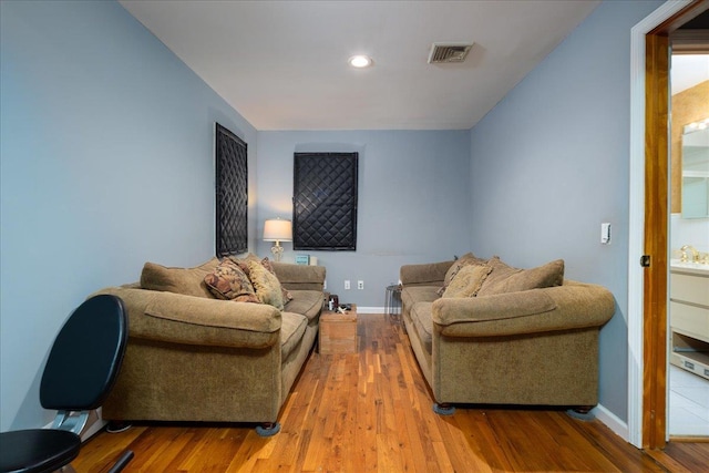 1360 Powell Ave, Merrick, NY 11566 - living room featuring wood finished floors and recessed lighting