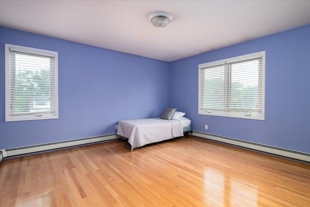 1360 Powell Ave, Merrick, NY 11566 - unfurnished bedroom with a baseboard radiator and light wood finished floors
