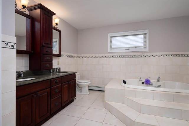 1360 Powell Ave, Merrick, NY 11566 - bathroom with baseboard heating, a bath, double vanity, tile patterned floors, and tile walls