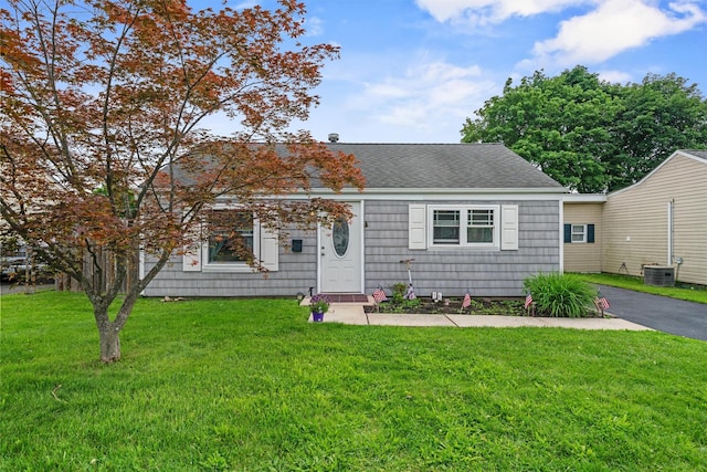 36 Peck St, Haverstraw, NY 10993 - view of front of house featuring roof with shingles, a front lawn, and central air condition unit