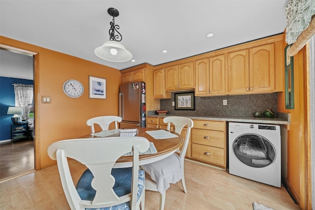 36 Peck St, Haverstraw, NY 10993 - kitchen with washer / clothes dryer, freestanding refrigerator, decorative backsplash, light wood finished floors, and hanging light fixtures