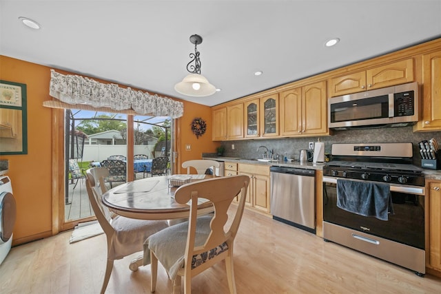 36 Peck St, Haverstraw, NY 10993 - kitchen featuring stainless steel appliances, a sink, light wood-style flooring, decorative backsplash, and recessed lighting