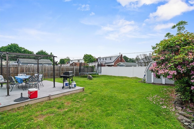 36 Peck St, Haverstraw, NY 10993 - view of yard featuring a trampoline, a wooden deck, and a storage shed