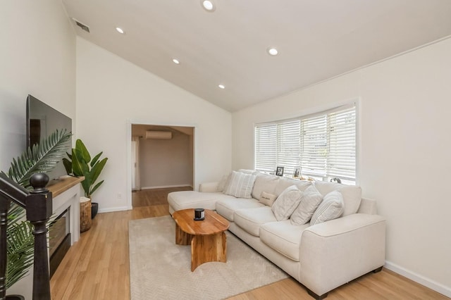 64 W Granada Ave, Lindenhurst, NY 11757 - living room featuring vaulted ceiling, light wood-type flooring, recessed lighting, baseboards, and a wall unit AC