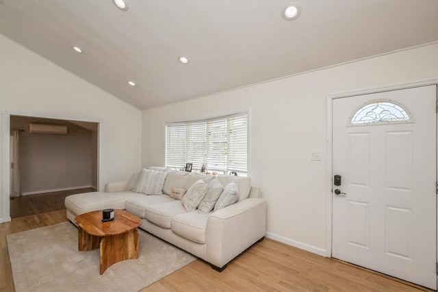 64 W Granada Ave, Lindenhurst, NY 11757 - living area featuring an AC wall unit, light wood-type flooring, lofted ceiling, recessed lighting, and baseboards