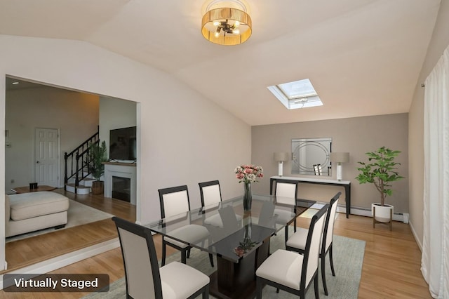 64 W Granada Ave, Lindenhurst, NY 11757 - dining room with vaulted ceiling, a skylight, light wood finished floors, stairs, and a chandelier