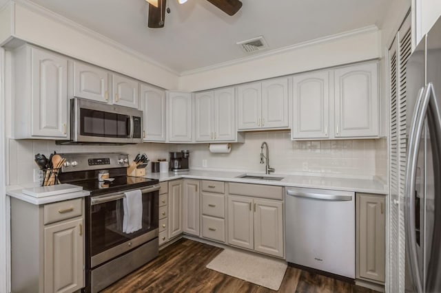 64 W Granada Ave, Lindenhurst, NY 11757 - kitchen featuring appliances with stainless steel finishes, a sink, ornamental molding, backsplash, and ceiling fan