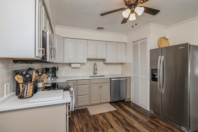 64 W Granada Ave, Lindenhurst, NY 11757 - kitchen with appliances with stainless steel finishes, a sink, crown molding, a ceiling fan, and dark wood-style flooring