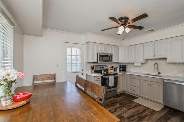 64 W Granada Ave, Lindenhurst, NY 11757 - kitchen featuring appliances with stainless steel finishes, a sink, ceiling fan, dark wood-type flooring, and crown molding