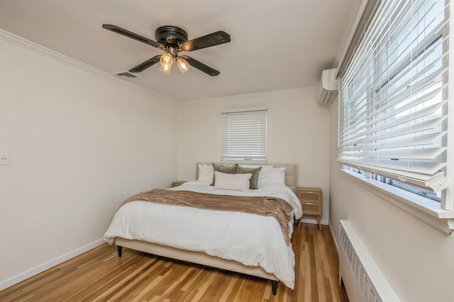 64 W Granada Ave, Lindenhurst, NY 11757 - bedroom featuring a wall unit AC, light wood-type flooring, crown molding, a ceiling fan, and baseboards