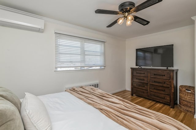 64 W Granada Ave, Lindenhurst, NY 11757 - bedroom with a wall mounted air conditioner, wood finished floors, ornamental molding, ceiling fan, and baseboards