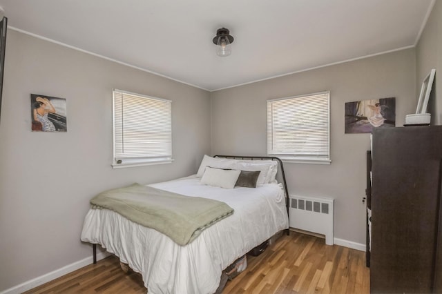 64 W Granada Ave, Lindenhurst, NY 11757 - bedroom with radiator heating unit, baseboards, wood finished floors, and ornamental molding