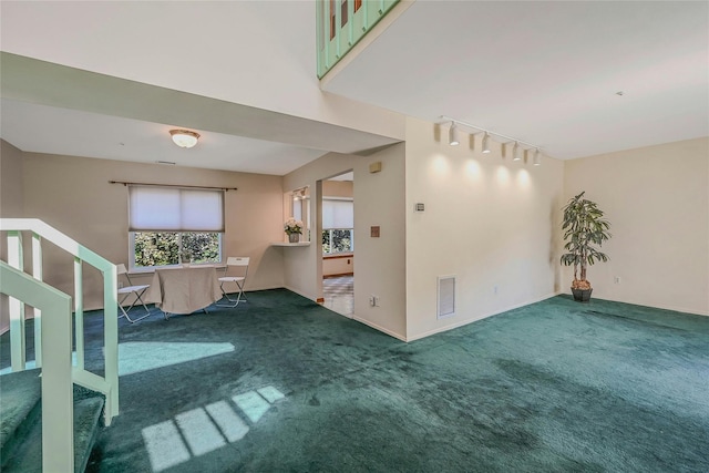 35 Gibbs Rd Unit 39, Coram, NY 11727 - carpeted spare room with rail lighting, stairway, and baseboards