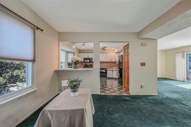 35 Gibbs Rd Unit 39, Coram, NY 11727 - dining space with dark colored carpet, baseboards, rail lighting, and ceiling fan