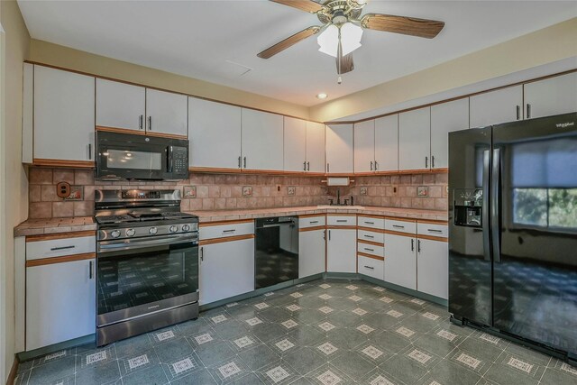 35 Gibbs Rd Unit 39, Coram, NY 11727 - kitchen with black appliances, a ceiling fan, dark floors, backsplash, and white cabinets