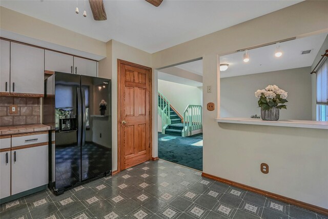 35 Gibbs Rd Unit 39, Coram, NY 11727 - kitchen with black fridge, dark floors, baseboards, rail lighting, and tile countertops