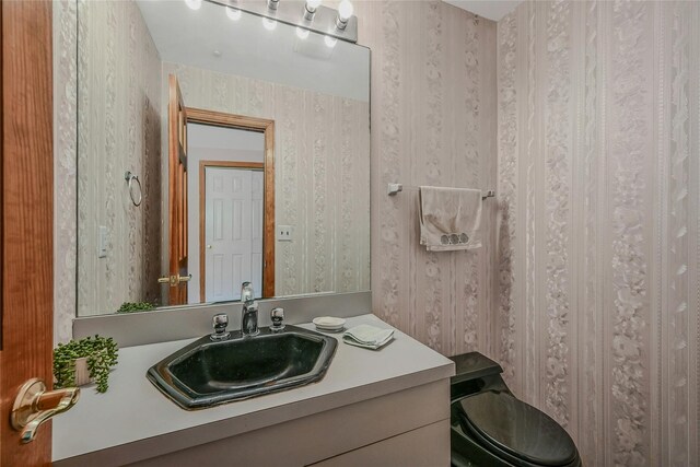 35 Gibbs Rd Unit 39, Coram, NY 11727 - bathroom with wallpapered walls, vanity, and toilet