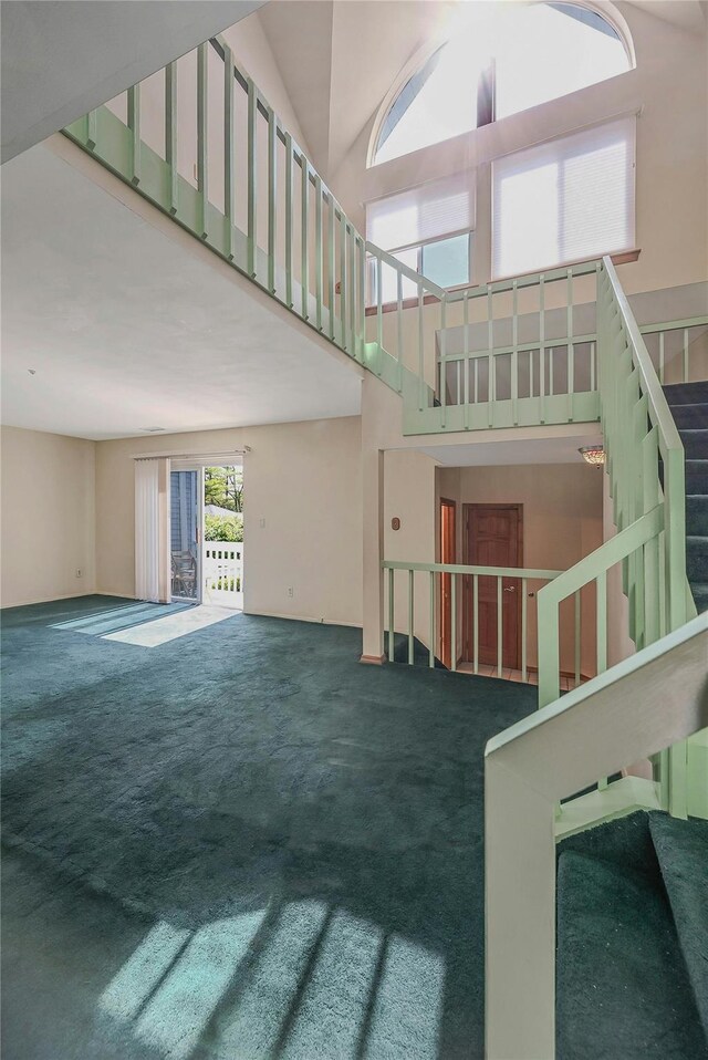 35 Gibbs Rd Unit 39, Coram, NY 11727 - unfurnished living room with a towering ceiling, carpet, and stairs