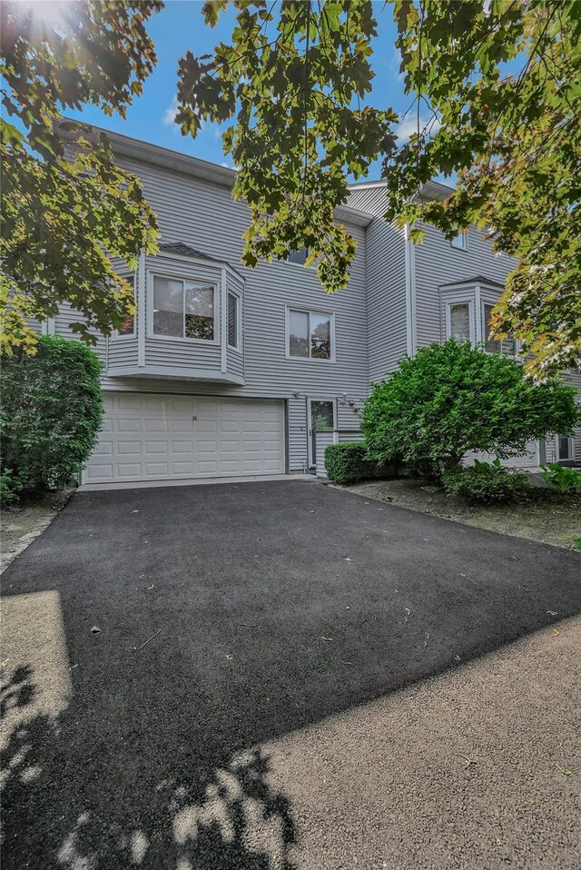 35 Gibbs Rd Unit 39, Coram, NY 11727 - view of property with a garage and asphalt driveway