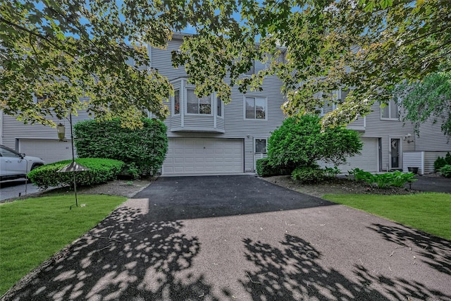 35 Gibbs Rd Unit 39, Coram, NY 11727 - view of property with driveway, a garage, and a front lawn