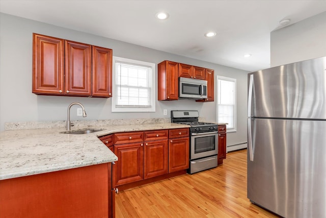 44 Wyoming Ave, Long Beach, NY 11561 - kitchen with appliances with stainless steel finishes, a sink, baseboard heating, light wood finished floors, and recessed lighting